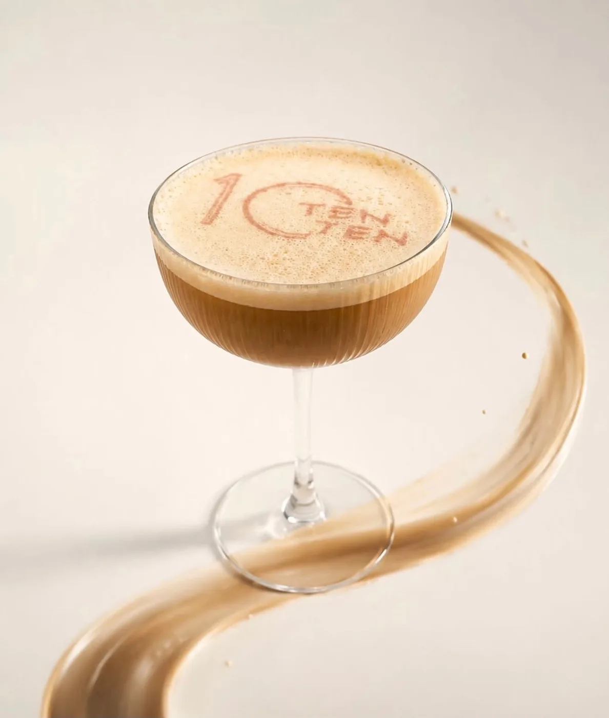 A TenTen espresso drink finished with the café's own logo stencilled in cocoa on the foam.