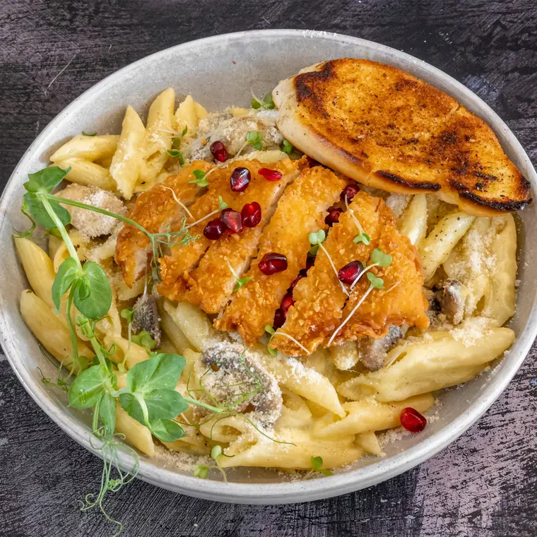 Creamy penne with breaded chicken, mushrooms and garlic bread.