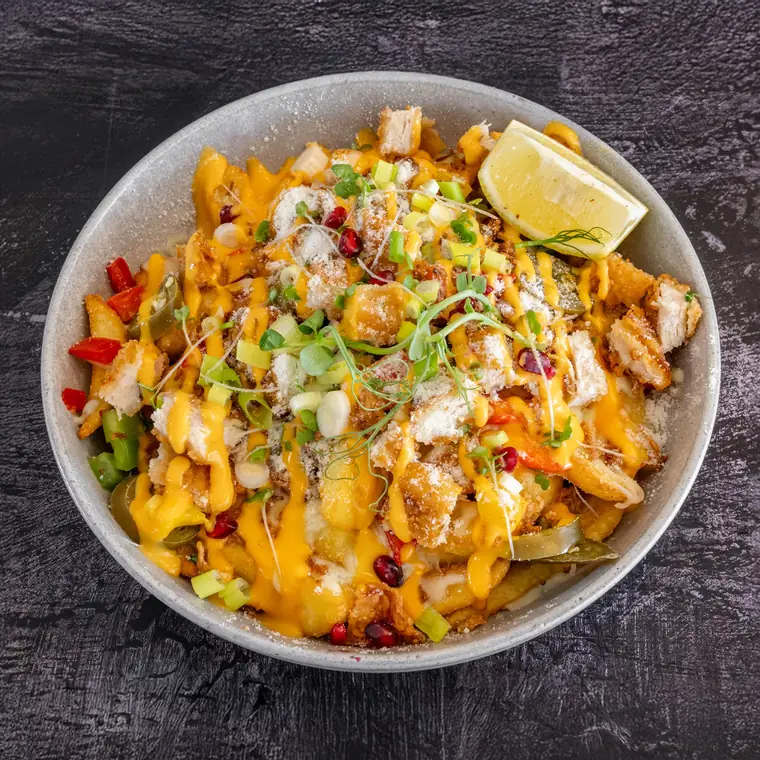 Loaded chips under melted cheese, spring onions and herbs.
