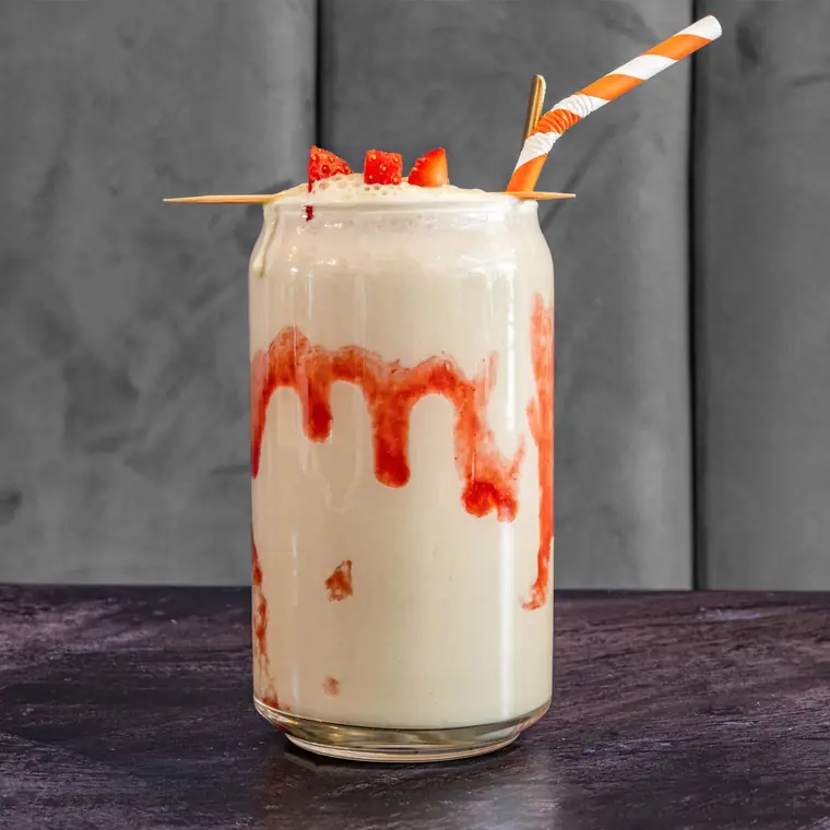 Strawberry milkshake laced with fruit purée and topped with fresh strawberries.