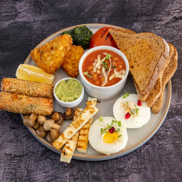 Veggie breakfast — halloumi sticks, hash browns, poached eggs, beans and toast.